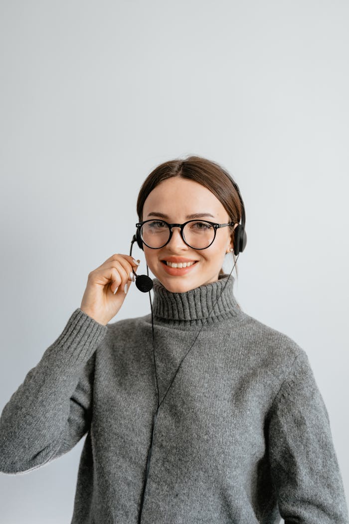 Friendly customer support woman smiling while wearing a headset in the office.